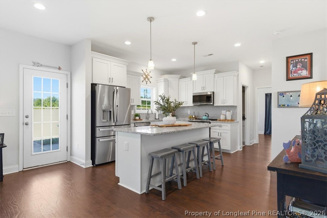 339 Rocking Horse Lane Raeford, NC 28376 - Photo 11 of 47 a kitchen with refrigerator and microwave