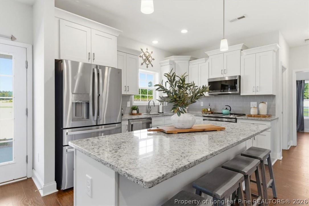 339 Rocking Horse Lane Raeford, NC 28376 - Photo 13 of 47 a kitchen with kitchen island a counter top space appliances and cabinets