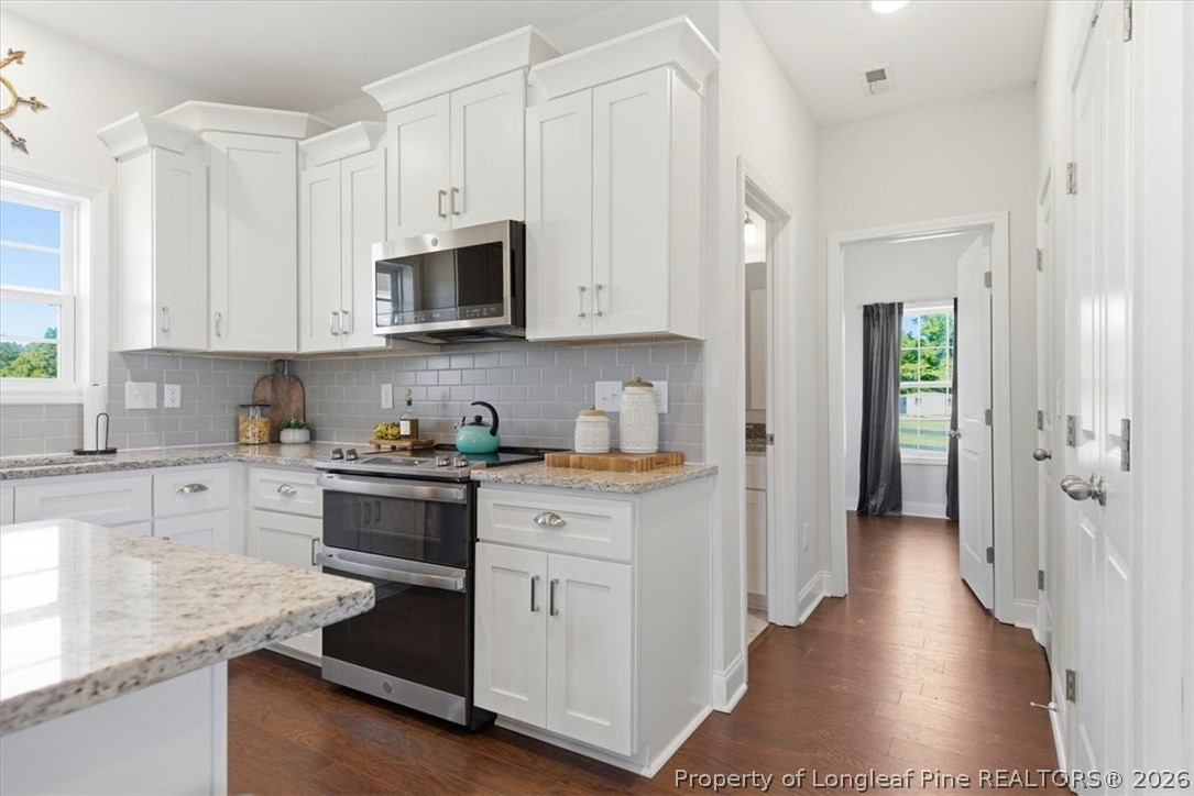 339 Rocking Horse Lane Raeford, NC 28376 - Photo 15 of 47 a kitchen with stainless steel appliances granite countertop a stove a sink and a refrigerator