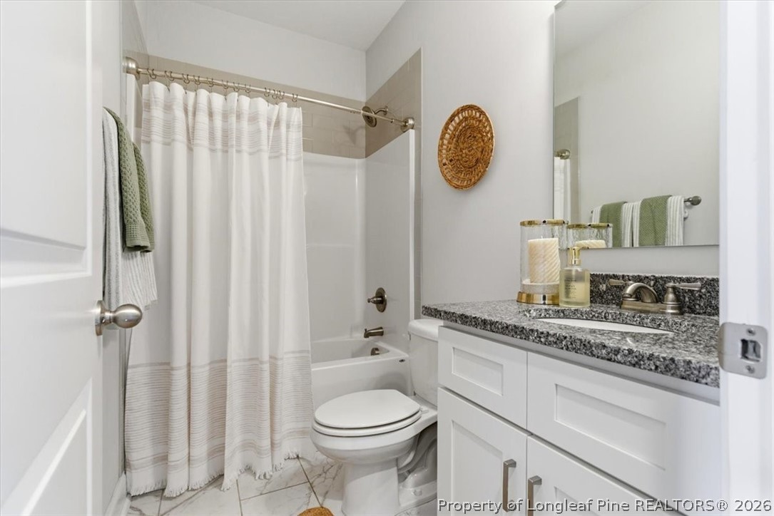 339 Rocking Horse Lane Raeford, NC 28376 - Photo 18 of 47 a bathroom with a granite countertop sink mirror vanity and toilet