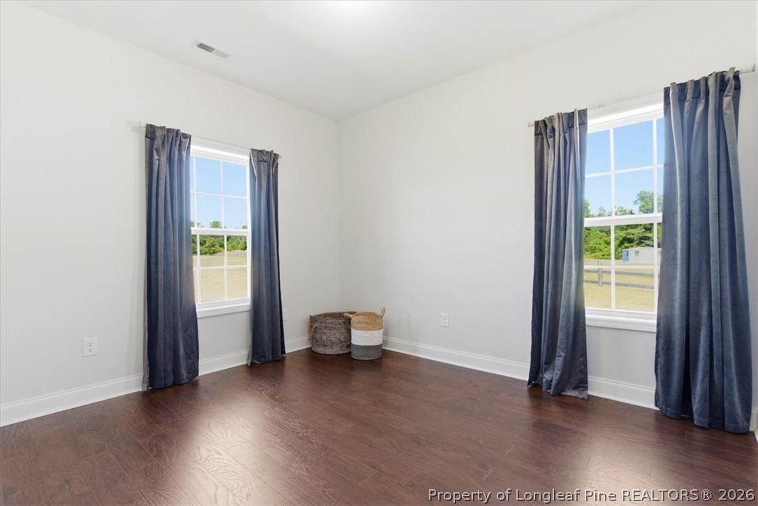 339 Rocking Horse Lane Raeford, NC 28376 - Photo 19 of 47 an empty room with wooden floor and windows