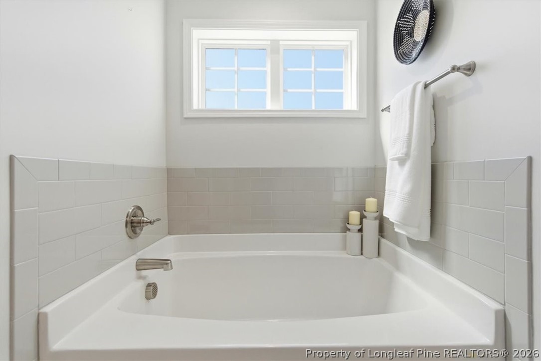 339 Rocking Horse Lane Raeford, NC 28376 - Photo 29 of 47 a white bath tub sitting next to a window