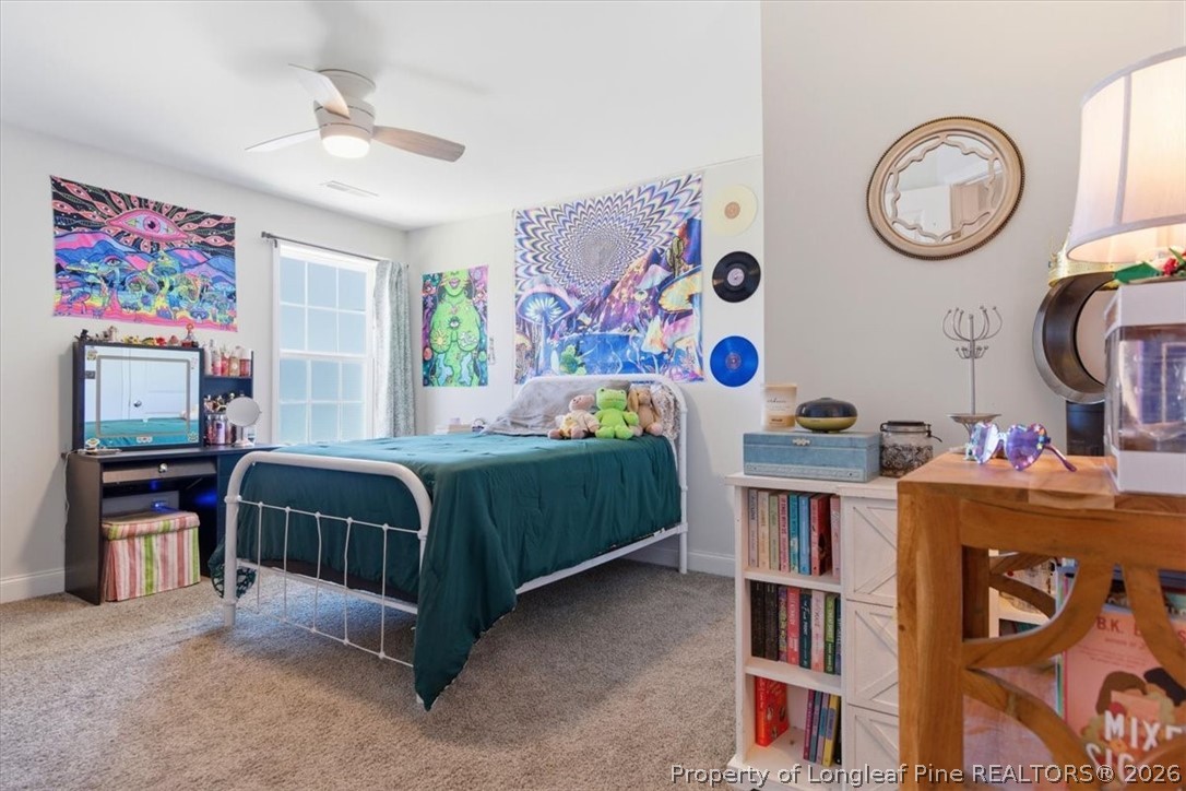 339 Rocking Horse Lane Raeford, NC 28376 - Photo 32 of 47 a bedroom with a bed a dresser and book shelf