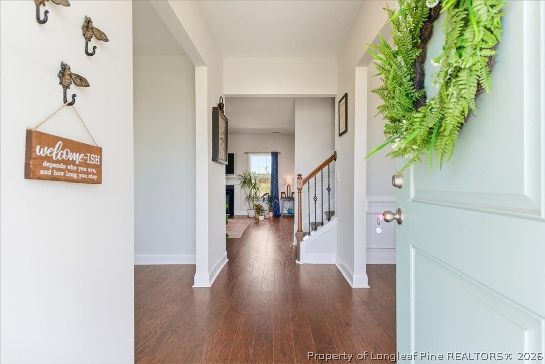 339 Rocking Horse Lane Raeford, NC 28376 - Photo 4 of 47 a view of a hallway with wooden floor and a potted plant