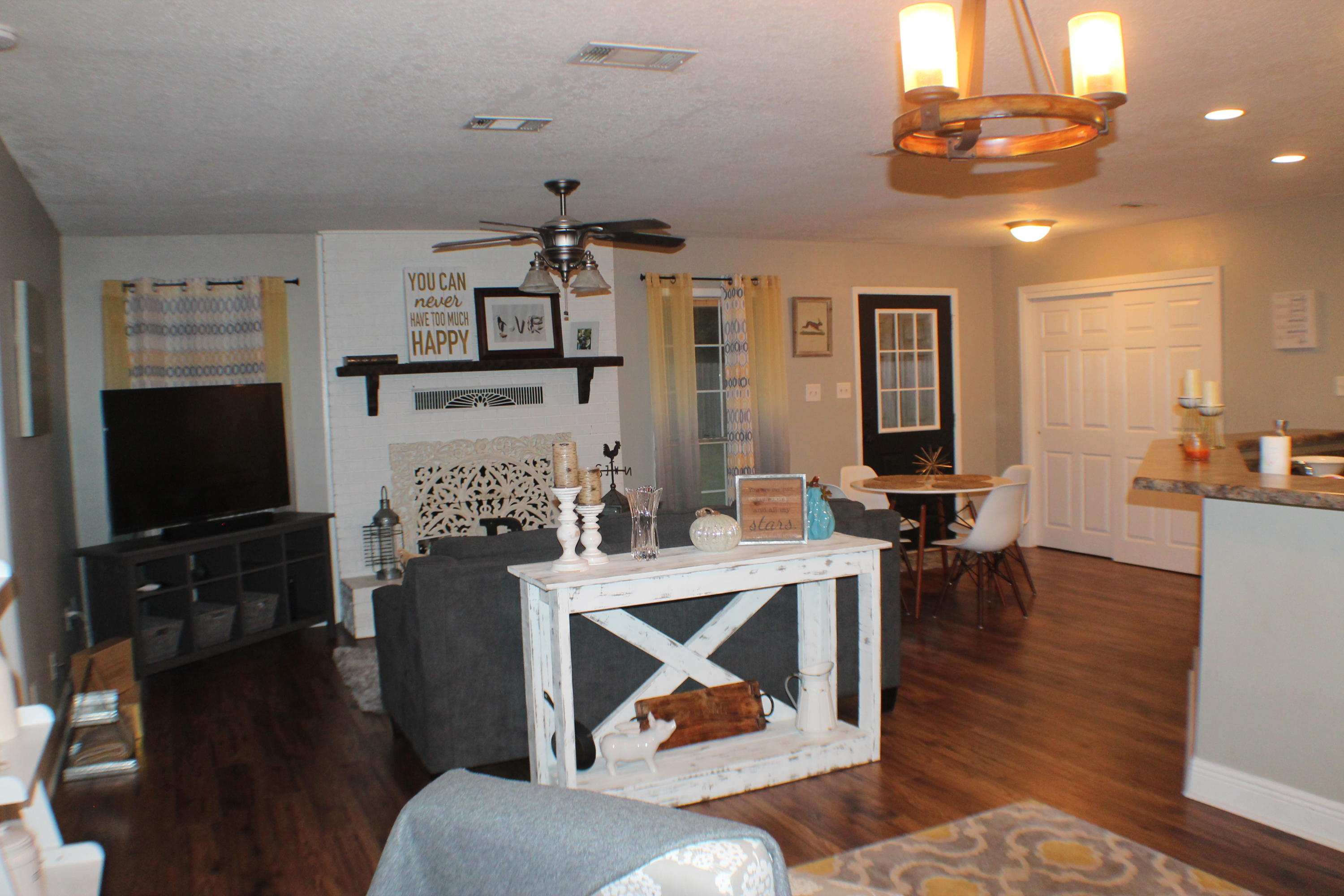 5843 Dairy Road Baker, FL 32531 - Photo 11 of 37 a living room with furniture a flat screen tv and kitchen view