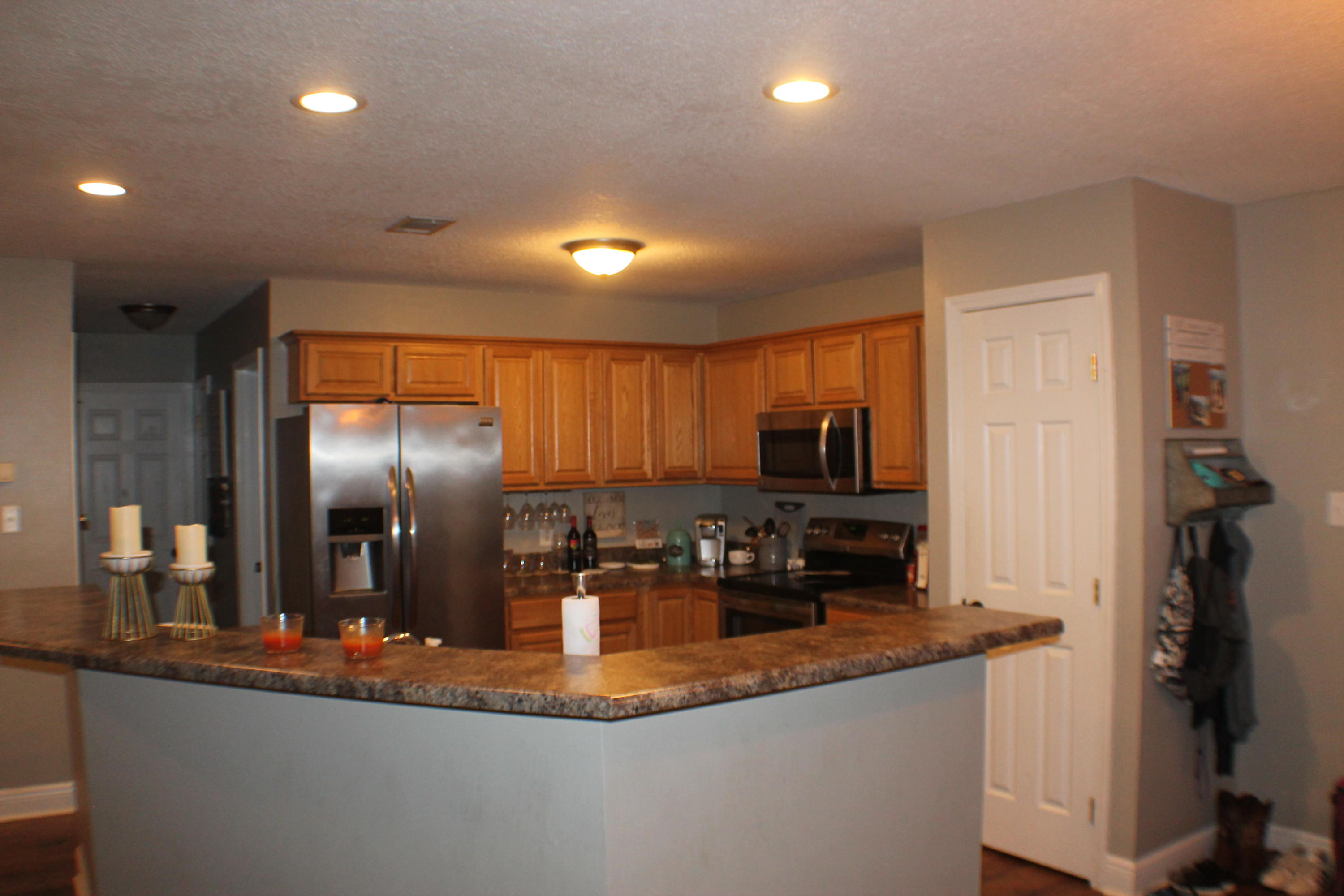 5843 Dairy Road Baker, FL 32531 - Photo 12 of 37 a kitchen with stainless steel appliances granite countertop a sink stove and refrigerator