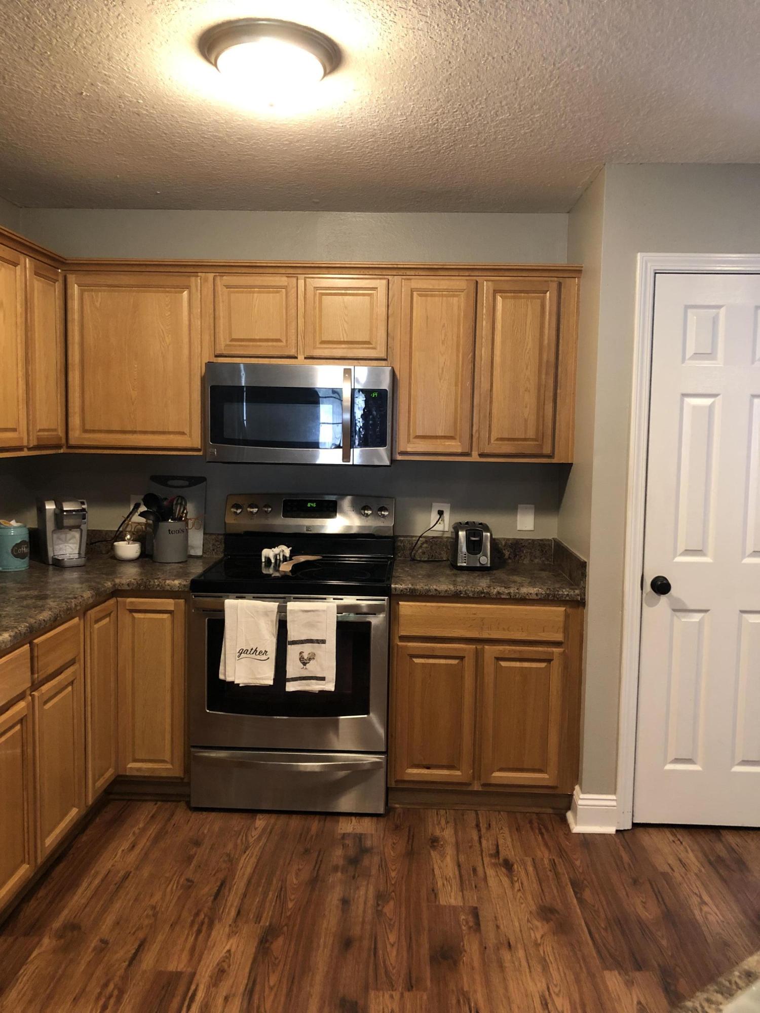 5843 Dairy Road Baker, FL 32531 - Photo 13 of 37 a kitchen with granite countertop a stove a sink and a microwave