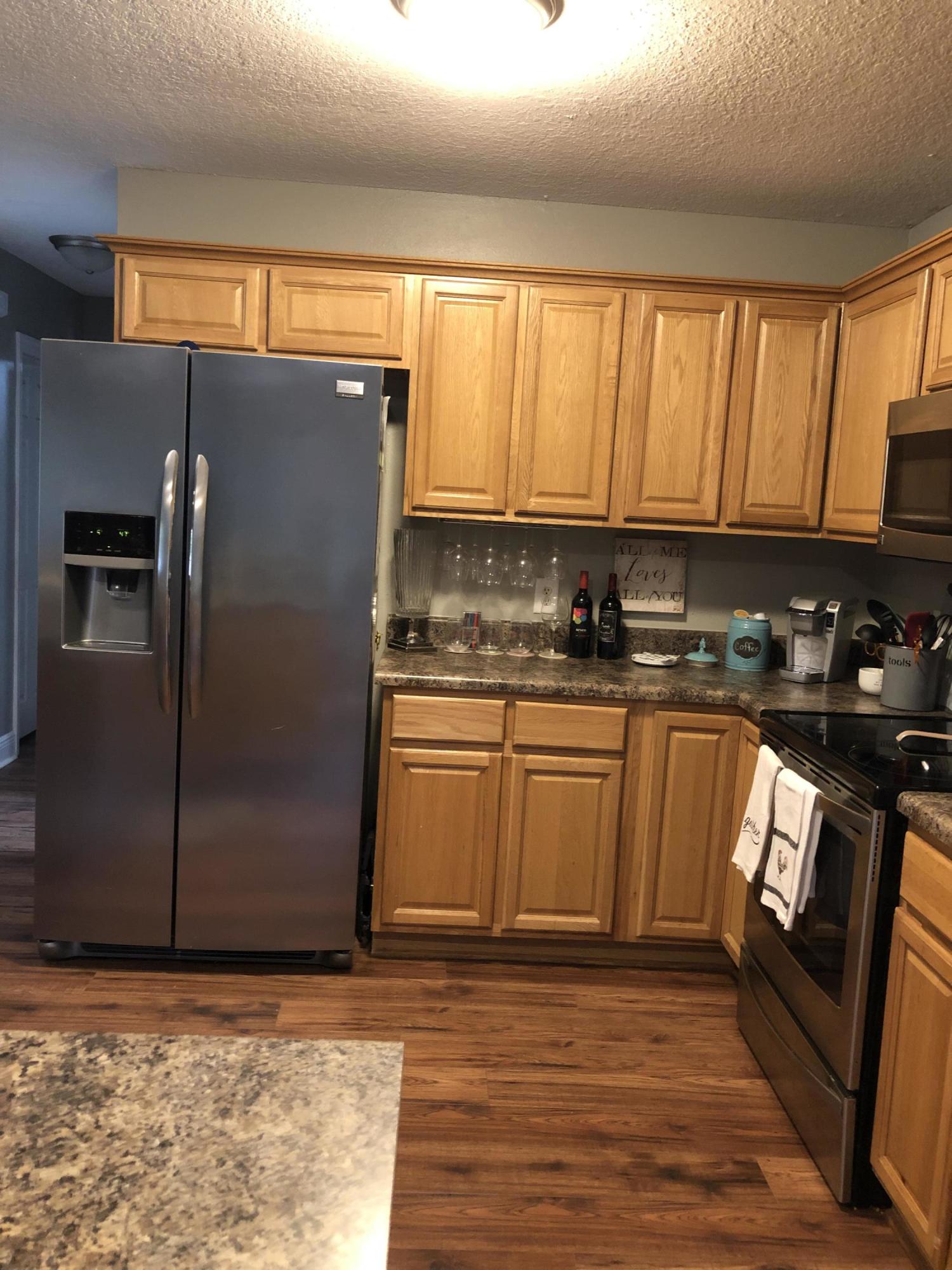 5843 Dairy Road Baker, FL 32531 - Photo 14 of 37 a kitchen with stainless steel appliances granite countertop a refrigerator a sink a stove and countertops with wooden floor