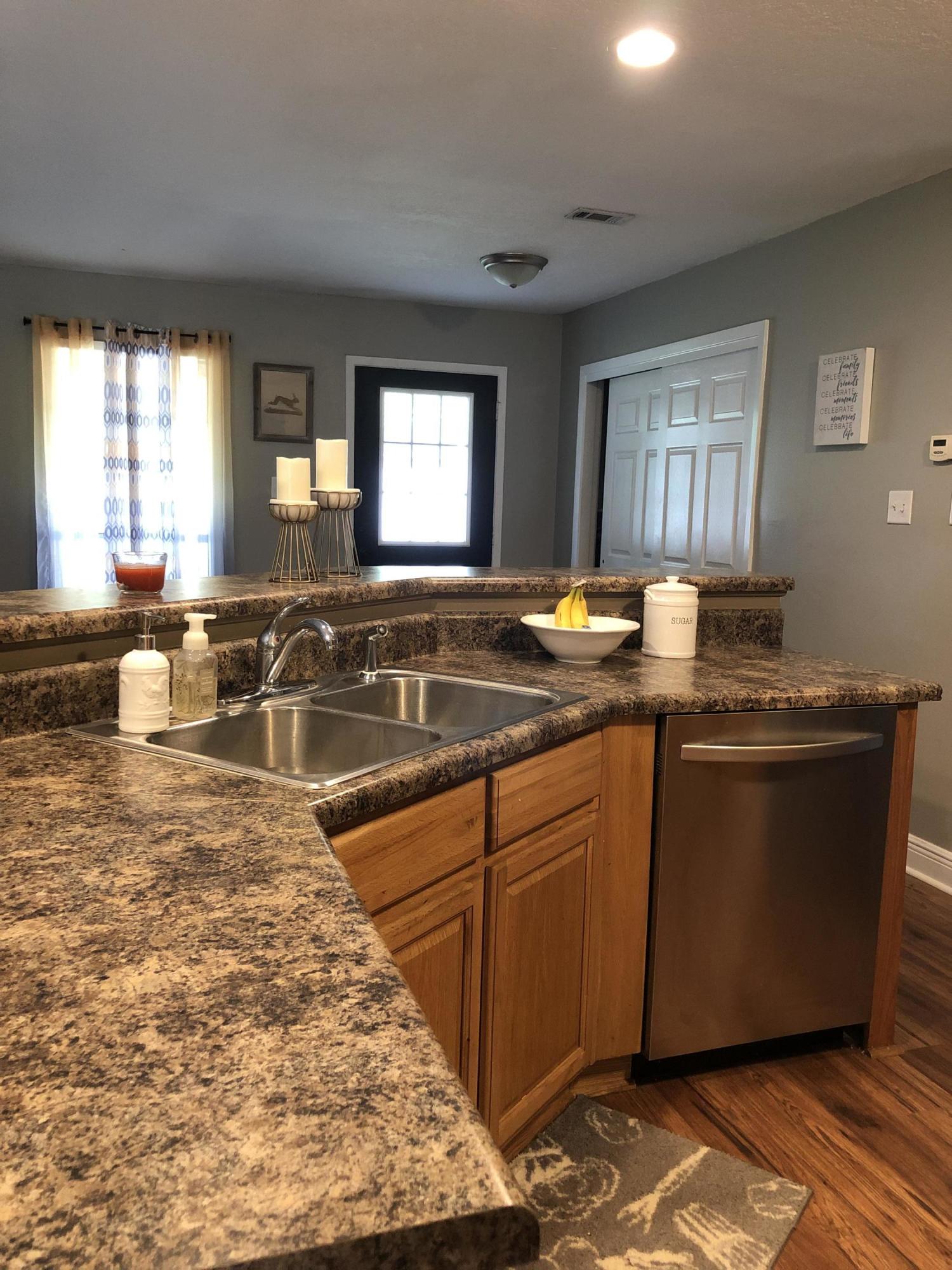 5843 Dairy Road Baker, FL 32531 - Photo 15 of 37 a kitchen with granite countertop a sink and a stove