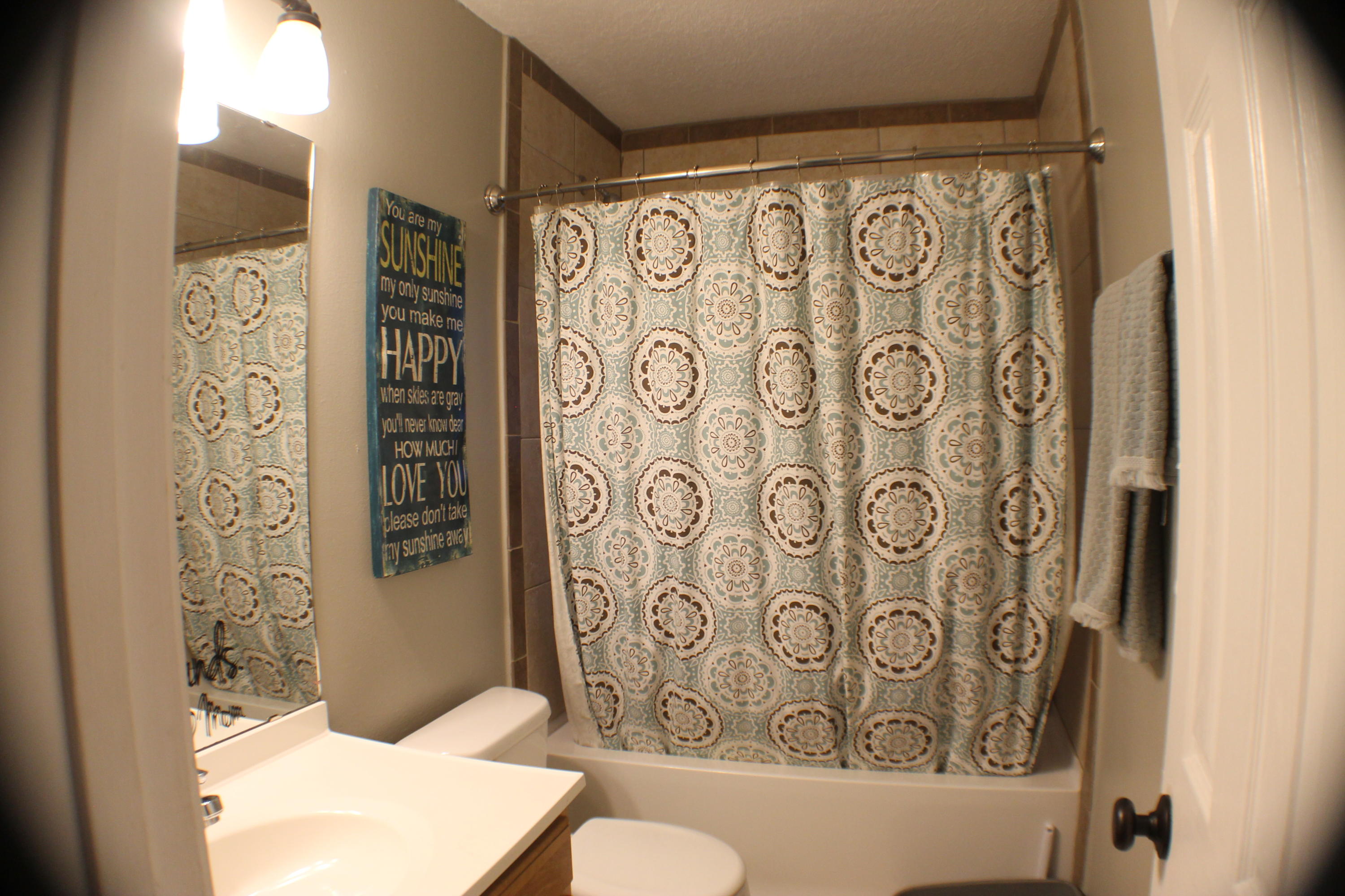 5843 Dairy Road Baker, FL 32531 - Photo 17 of 37 a bathroom with a toilet and shower curtain