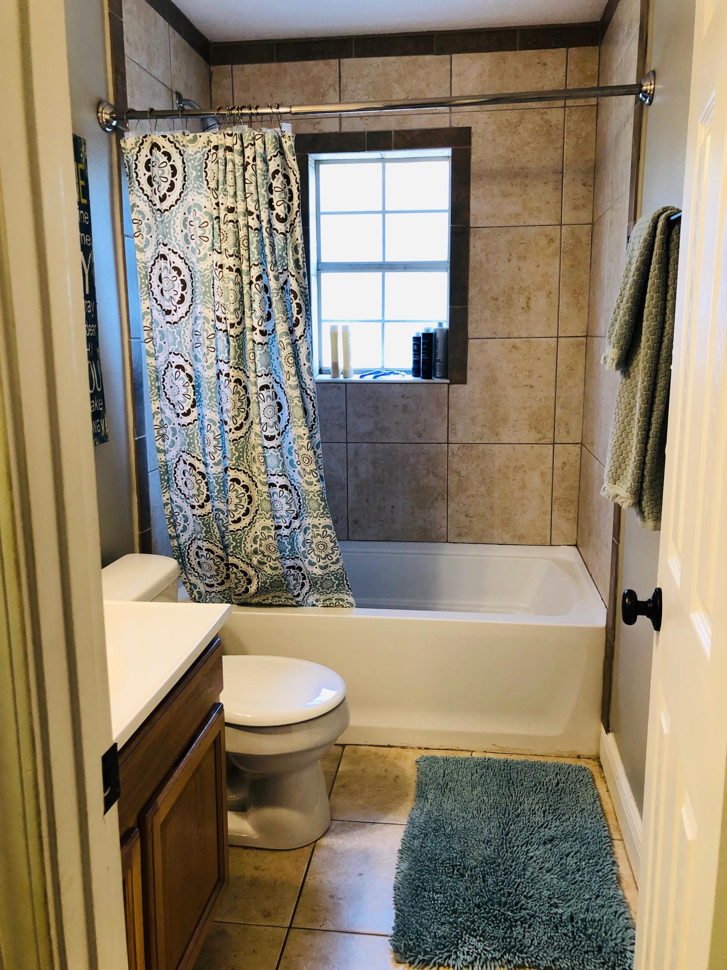 5843 Dairy Road Baker, FL 32531 - Photo 18 of 37 a bathroom with a bathtub and shower