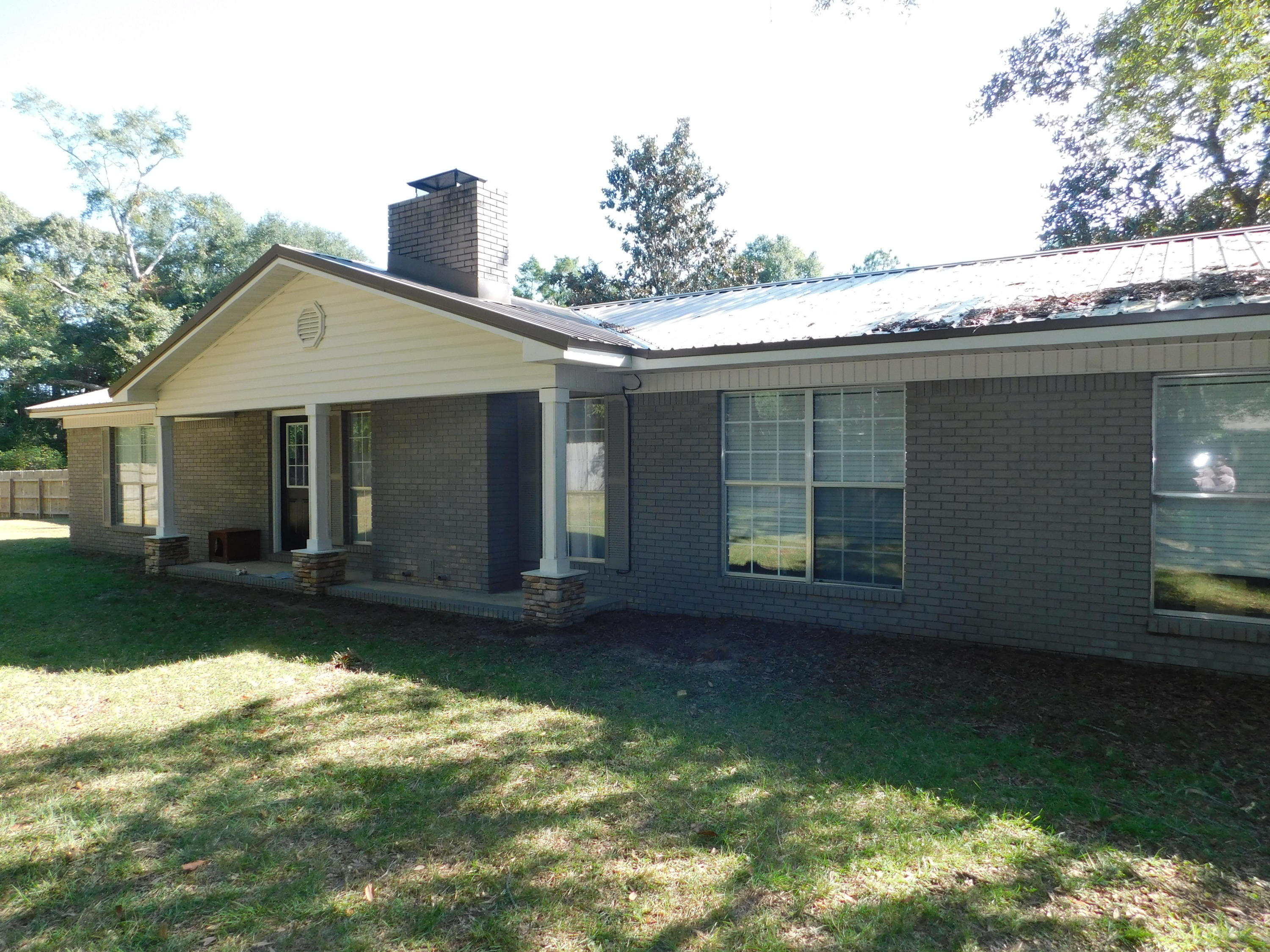 5843 Dairy Road Baker, FL 32531 - Photo 2 of 37 a view of a house with a yard plants and a patio