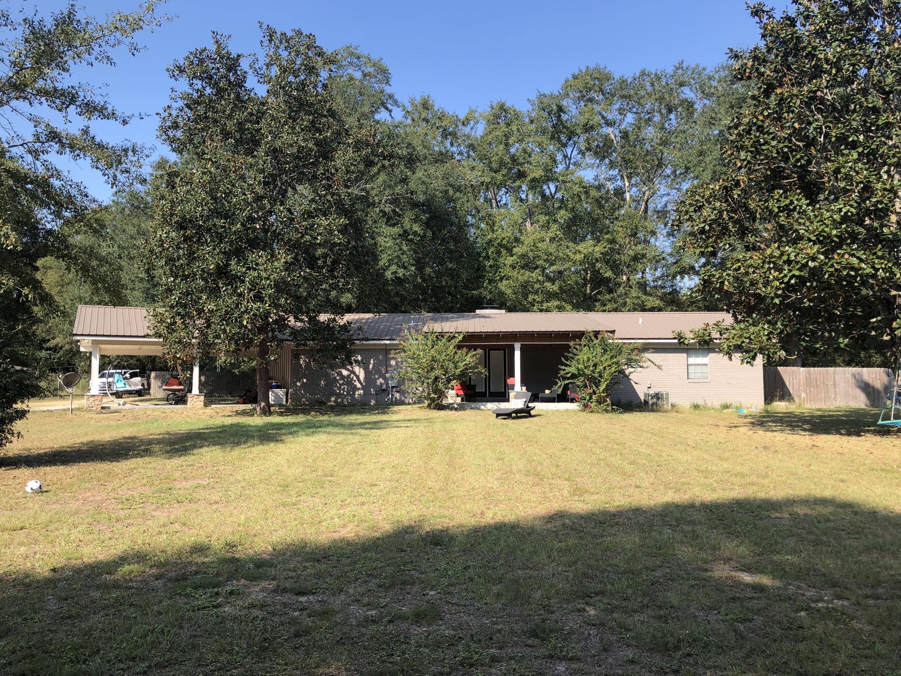 5843 Dairy Road Baker, FL 32531 - Photo 27 of 37 a front view of a house with a yard and garage