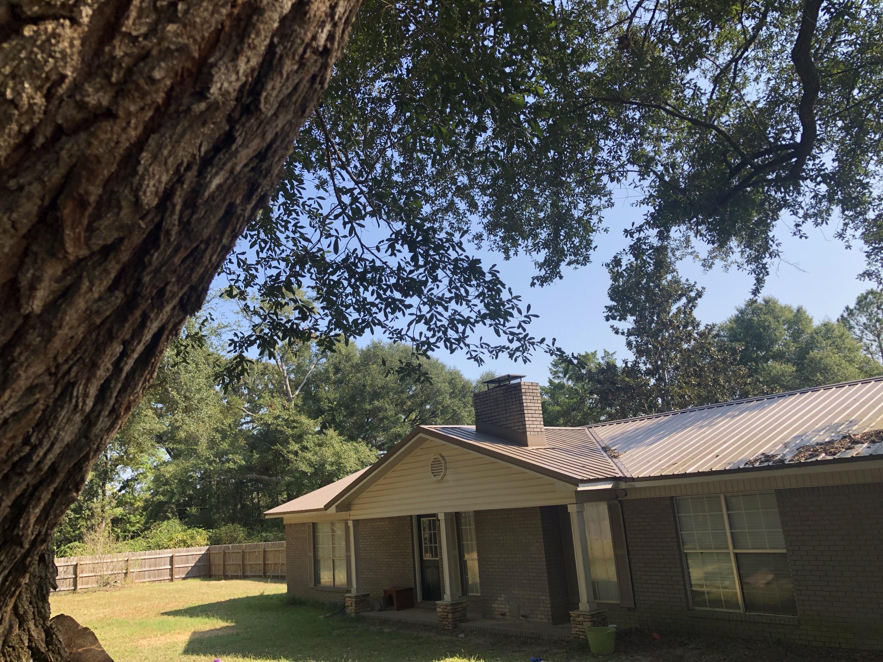 5843 Dairy Road Baker, FL 32531 - Photo 28 of 37 a view of a house with a yard
