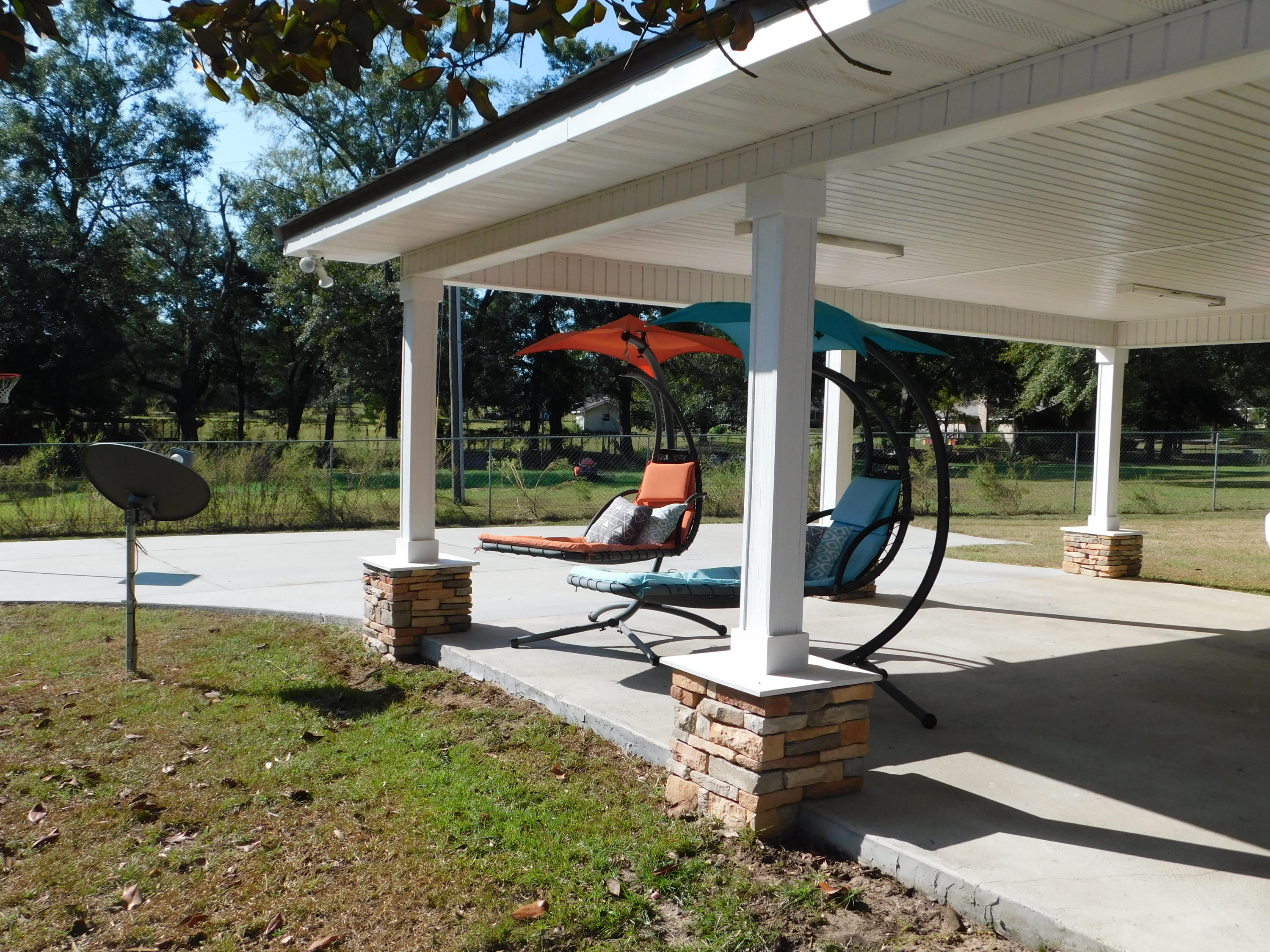 5843 Dairy Road Baker, FL 32531 - Photo 30 of 37 a view of a patio with a table chairs and garden