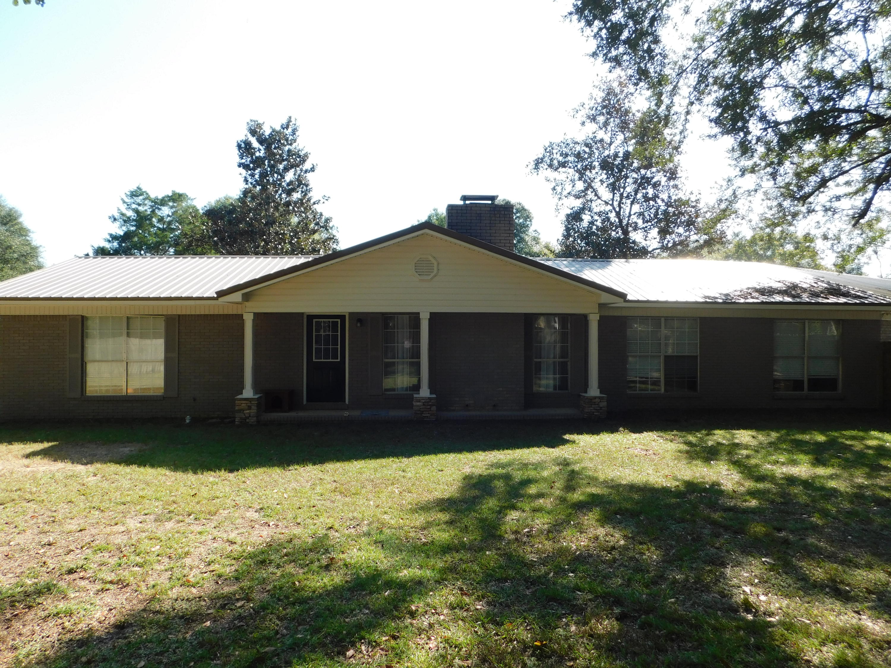 5843 Dairy Road Baker, FL 32531 - Photo 3 of 37 a front view of a house with a yard
