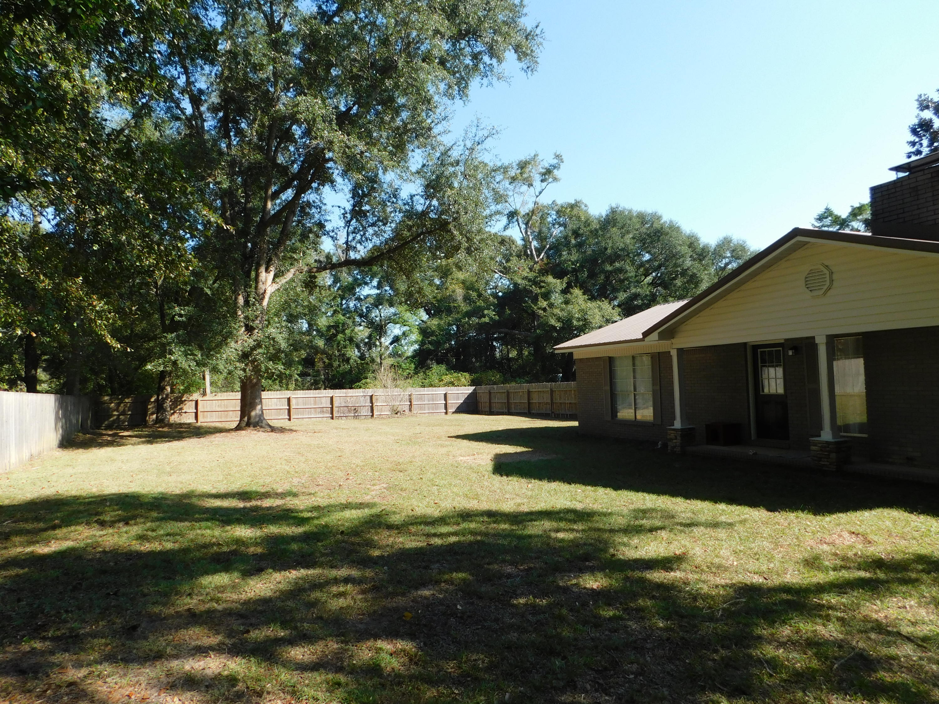 5843 Dairy Road Baker, FL 32531 - Photo 32 of 37 a view of a yard in front of a house with large trees