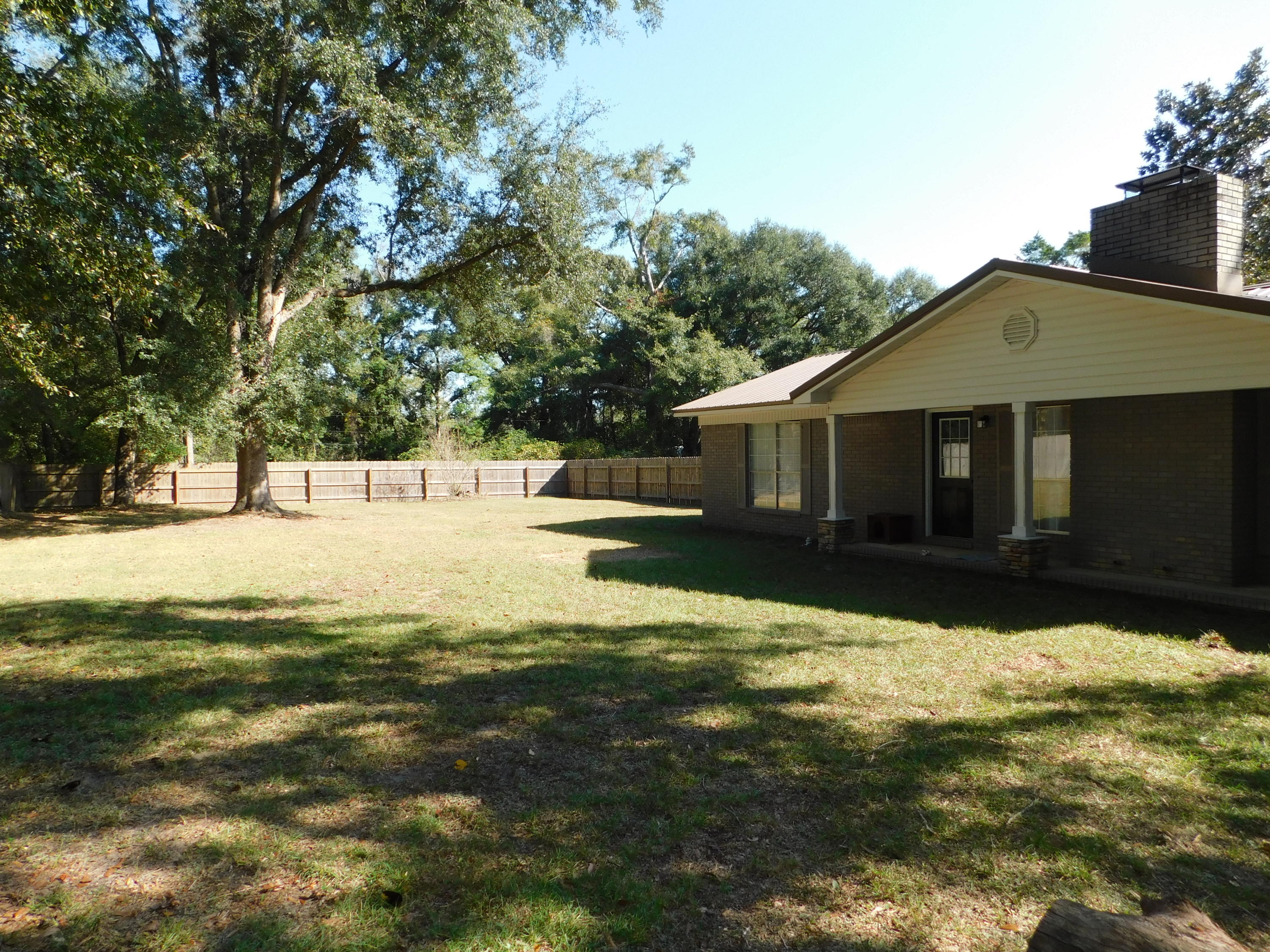 5843 Dairy Road Baker, FL 32531 - Photo 33 of 37 a view of a house with a yard