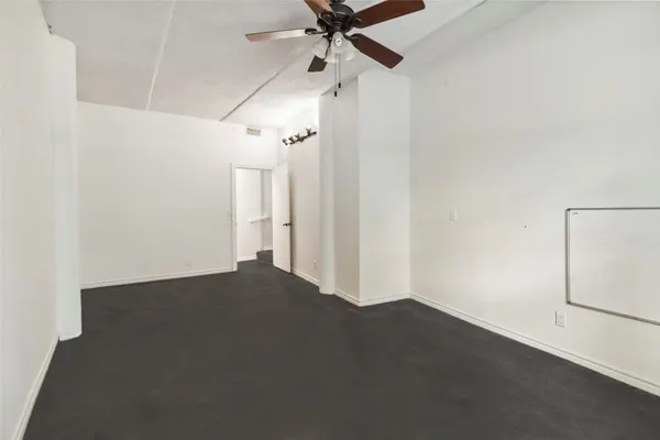 an empty room with a empty space and a ceiling fan