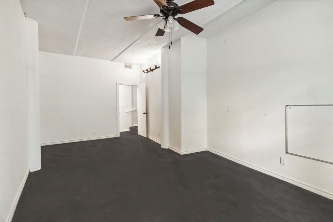 208 Old Potato Road Paige, TX 78659 - Photo 15 of 40 an empty room with a empty space and a ceiling fan