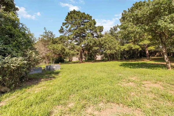 a view of outdoor space with garden and trees