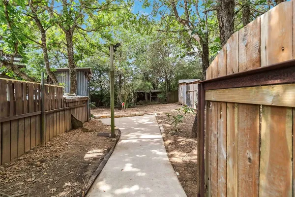 a view of a house with a wooden fence