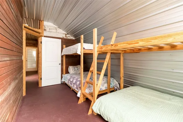 a bed sitting in a bedroom next to a window