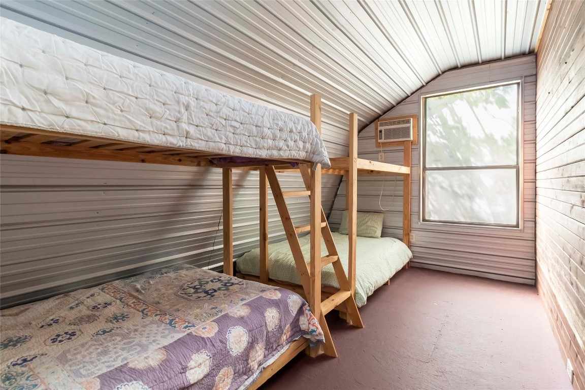 208 Old Potato Road Paige, TX 78659 - Photo 27 of 40 a bed sitting in a bedroom next to a window