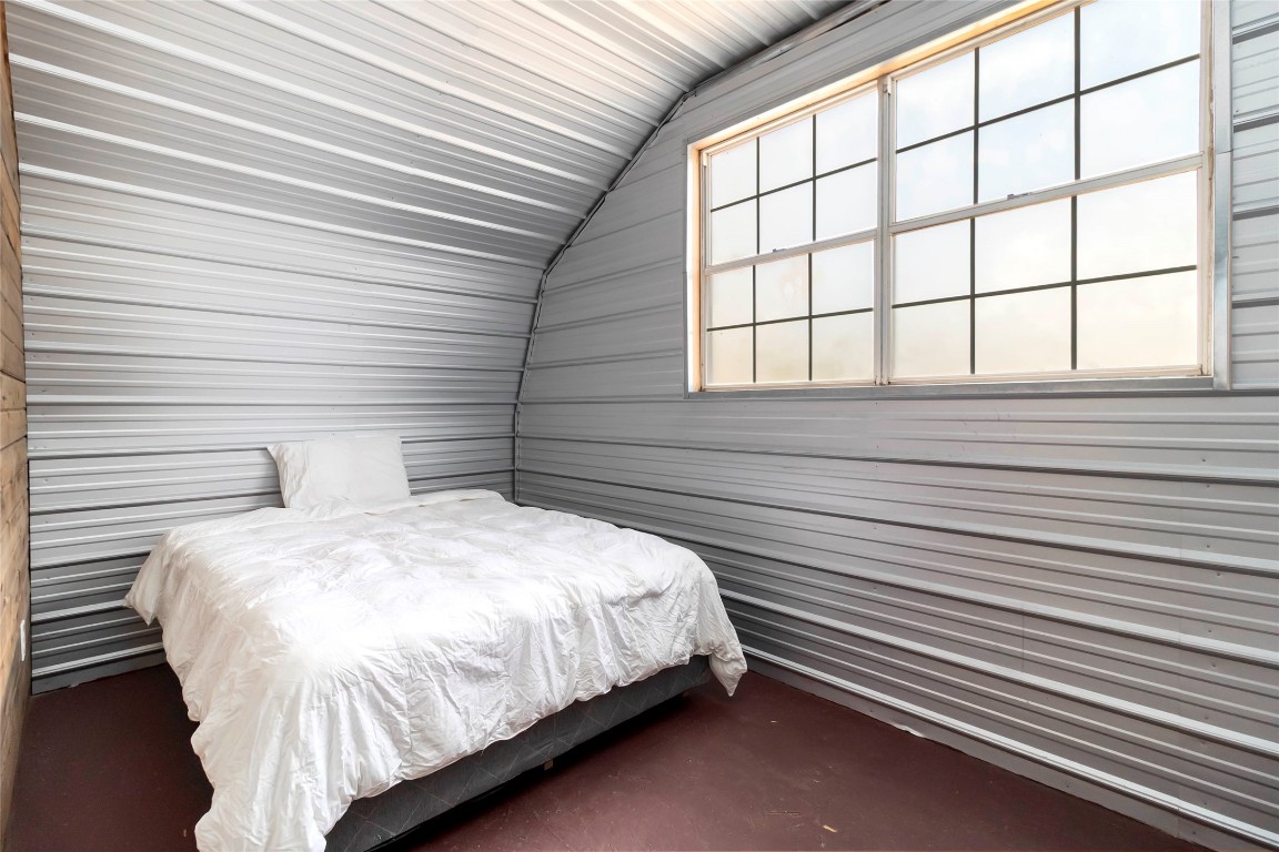 208 Old Potato Road Paige, TX 78659 - Photo 29 of 40 a bed sitting in a bedroom next to a window