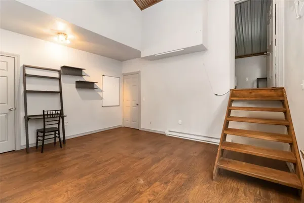 a bedroom with a bed and a book shelf