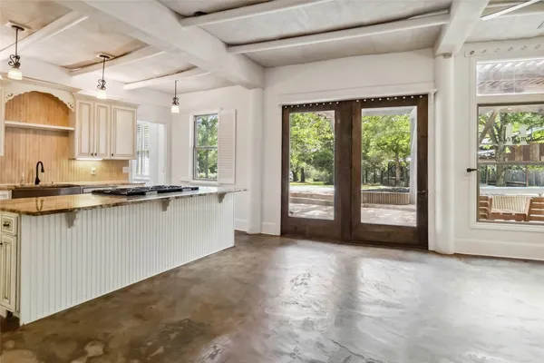 a view of a kitchen with microwave and a sink