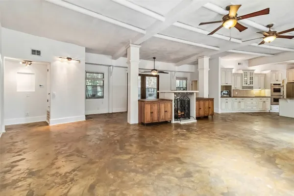 a view of a kitchen with refrigerator and windows