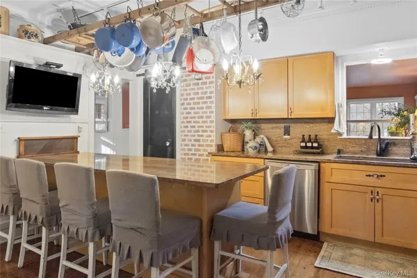a kitchen with stainless steel appliances granite countertop a sink and a microwave