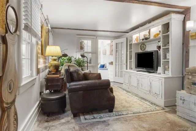 a living room with furniture a flat screen tv and a fireplace