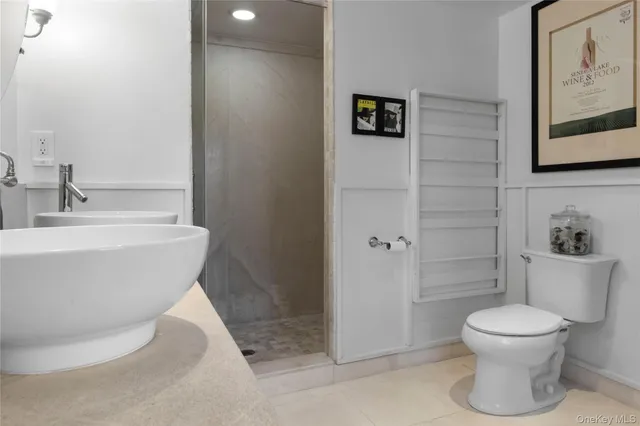 a bathroom with a granite countertop shower and a sink