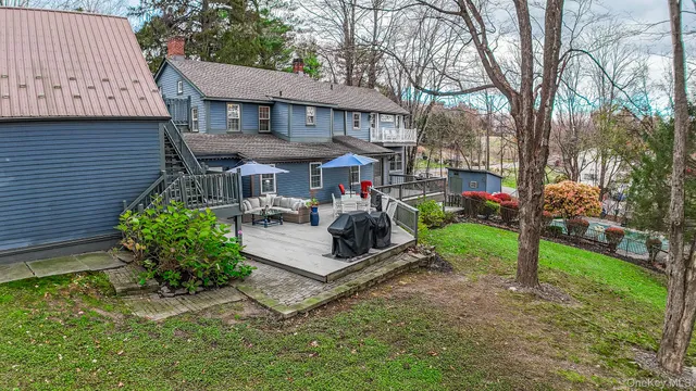 a view of a patio with a table and chairs under an umbrella