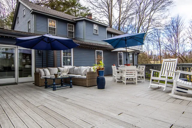 a view of a patio with couches near a yard