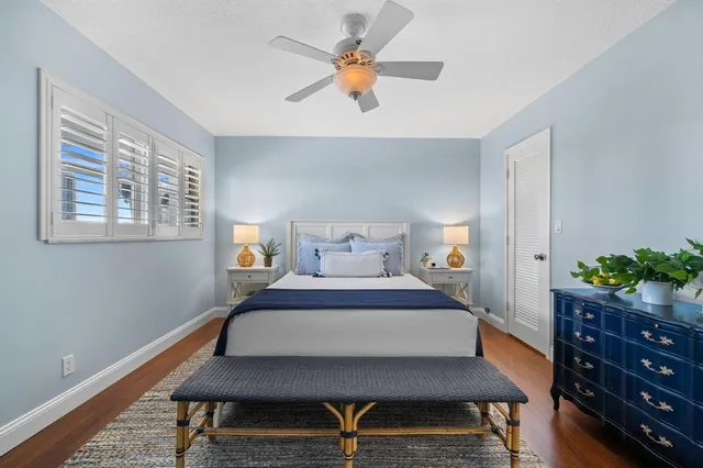 a bedroom with a bed and a potted plant