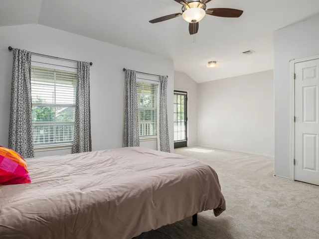 a bedroom with a large bed and a large window