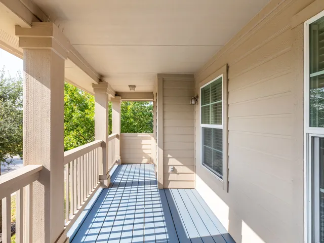 a view of a balcony with wooden floor