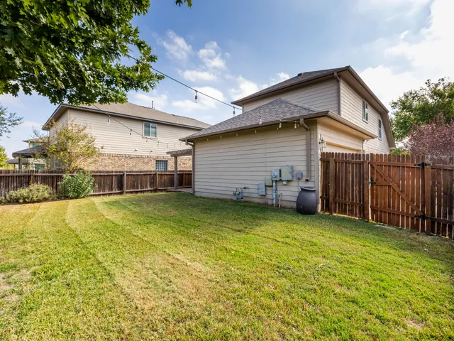 a front view of house with yard and garage