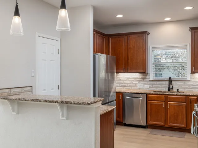 a kitchen with stainless steel appliances a sink and cabinets