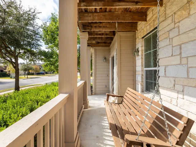 a view of a porch with wooden floor and fence