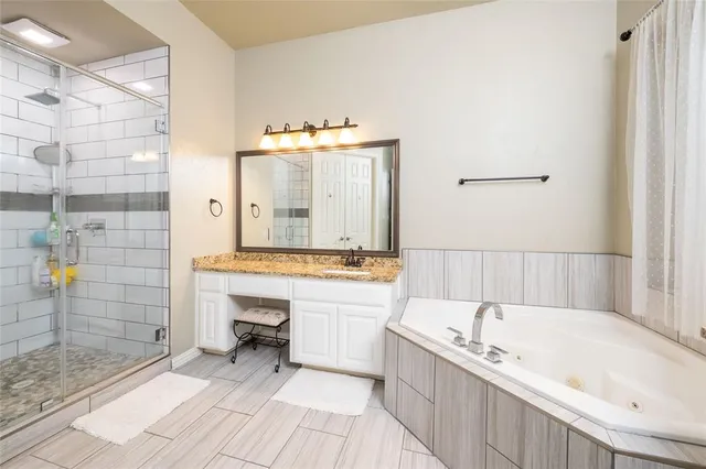 a bathroom with a tub sink and mirror