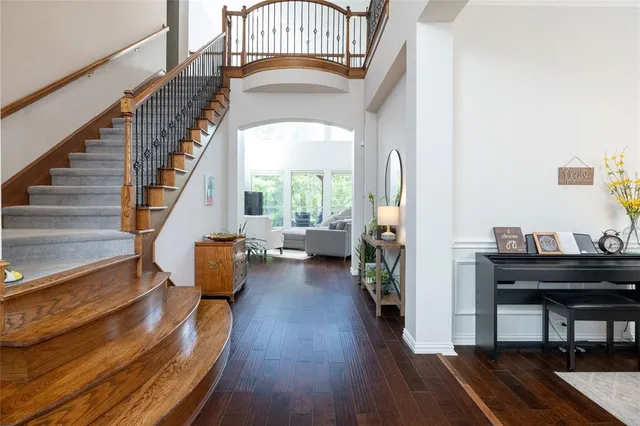a view of entryway and hall with wooden floor