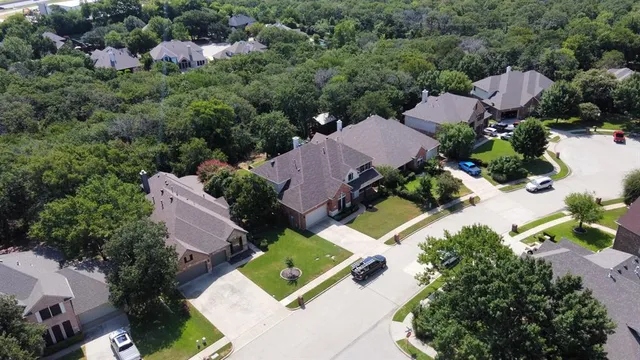an aerial view of a house with outdoor space and a lake view