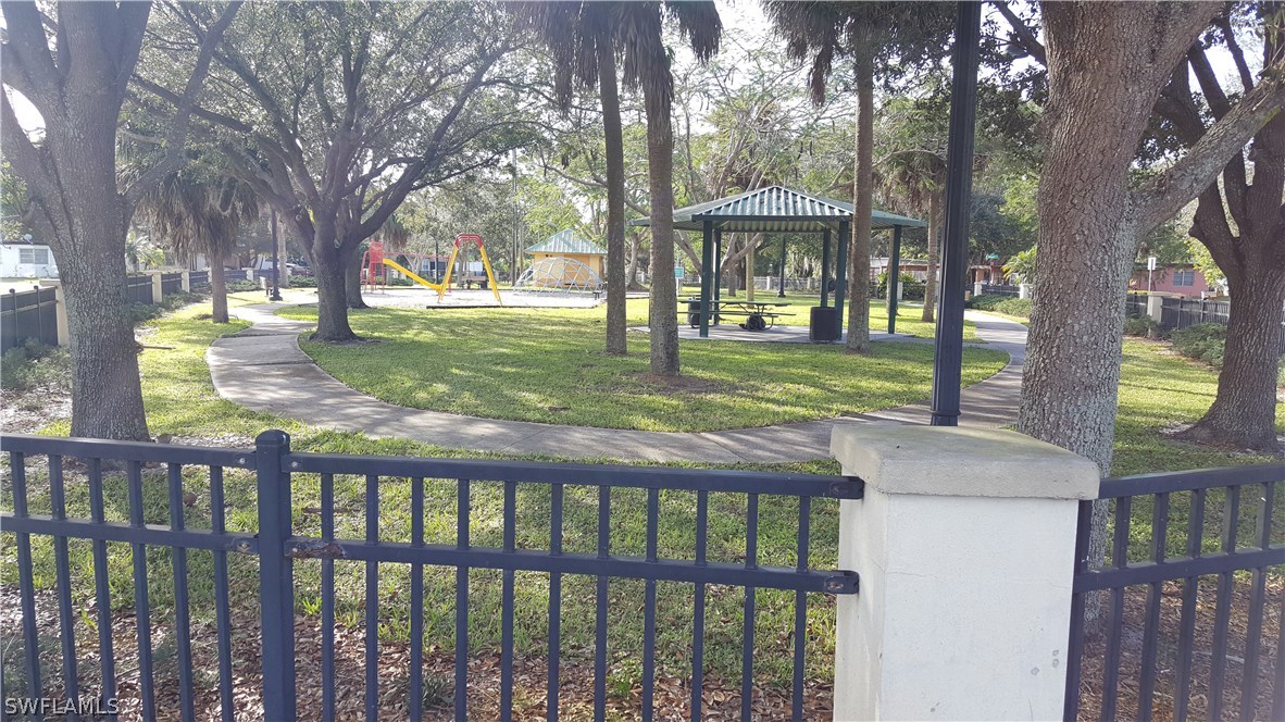 1924 Coronado Road Fort Myers, FL 33901 - Photo 11 of 11 a view of a wooden deck next to a yard with a large tree