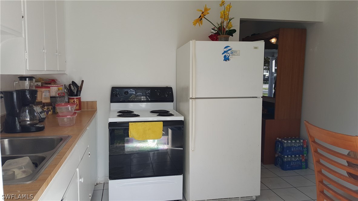 1924 Coronado Road Fort Myers, FL 33901 - Photo 5 of 11 a white refrigerator freezer sitting inside of a kitchen