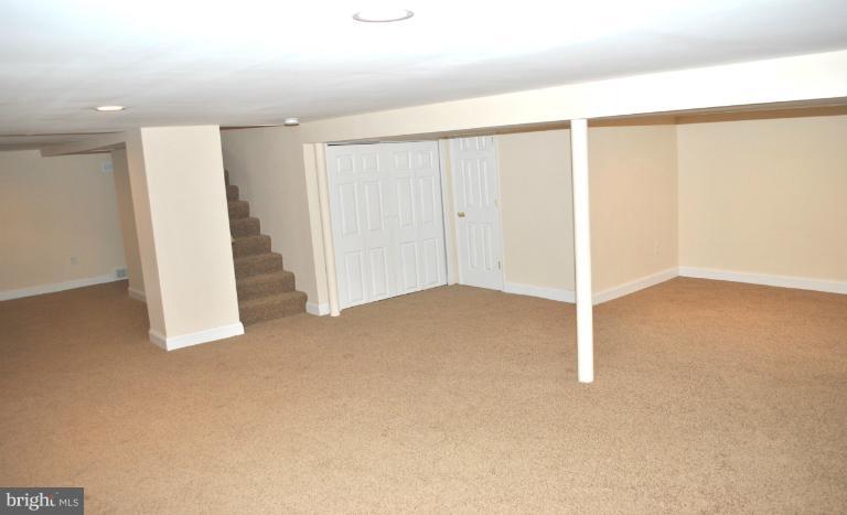 2820 Greenlawn Road Baltimore, MD 21207 - Photo 2 of 26 an empty room with a ceiling fan
