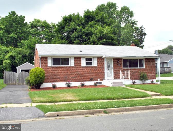 2820 Greenlawn Road Baltimore, MD 21207 - Photo 13 of 26 a front view of a house with a yard and garage